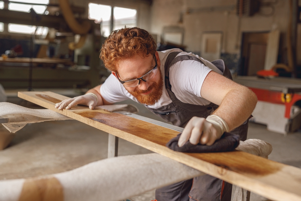 Craftsman,Coating,A,Wooden,Board,With,Protective,Oil,In,A