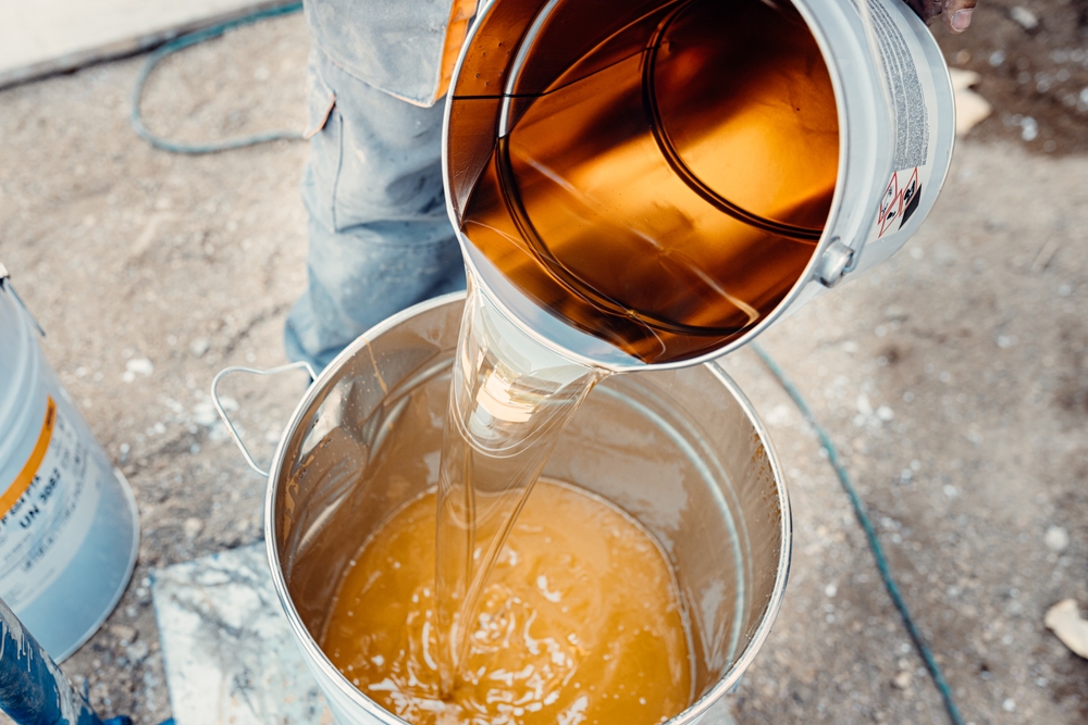 Pouring,Yellow,Resin,From,The,Metal,Bucket,For,Preparing,Floor