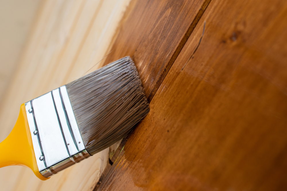 Painting,Teak,Wooden,Surface,With,A,Paintbrush