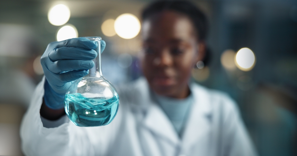 Scientist,Hand,,Woman,And,Beaker,With,Chemical,For,Biochemistry,,Experiment